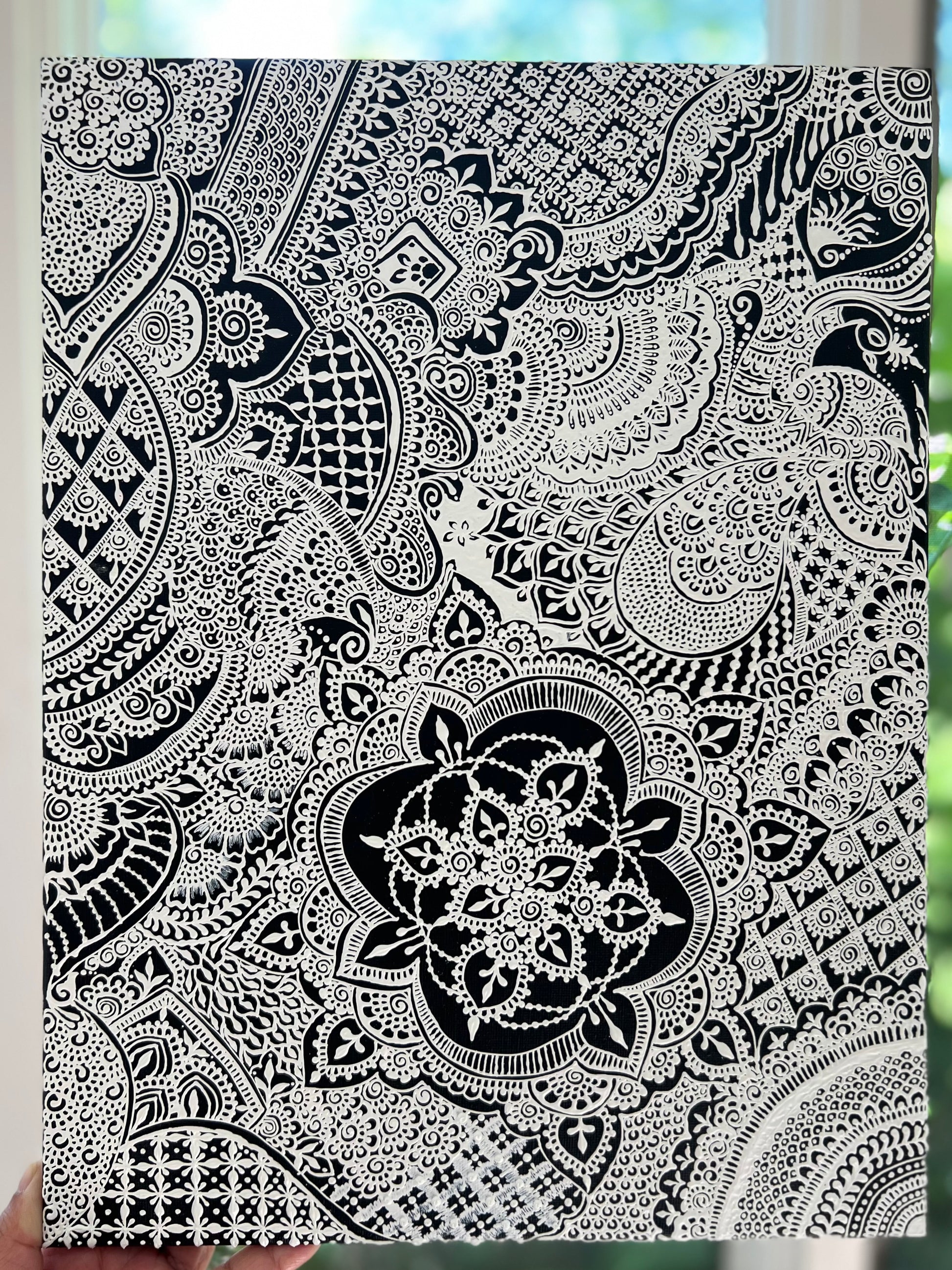 "Midnight Mehandi" artwork, focusing on intricate henna inspired designed created on a black background with white acrylic.